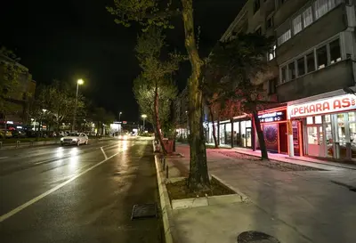 a street at night with a car parked on the street at Apartman Centar 2 in Podgorica