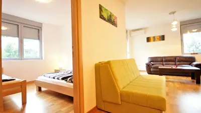 a living room with a couch and a chair at Pavlina Apartments Budva in Budva