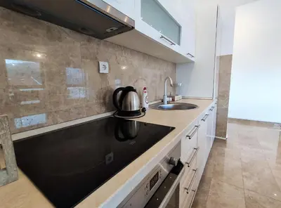 a kitchen with a sink and a tea kettle on the counter at Pavlina Apartments Budva in Budva