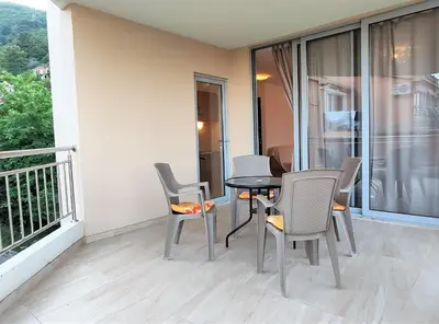 a balcony with a table and chairs on a balcony at Pavlina Apartments Budva in Budva