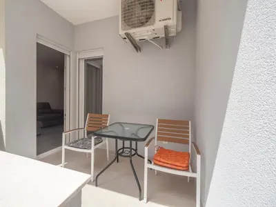 a small kitchen with a table and two chairs at Marea Apartments Budva in Budva