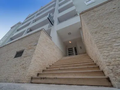 a building with stairs leading up to a building at Marea Apartments Budva in Budva
