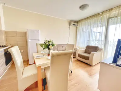 a kitchen and living room with a table and chairs at Adriatique Apartments in Dobra Voda