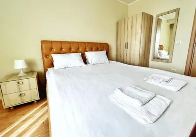 a bedroom with a large bed with two towels on it at Adriatique Apartments in Dobra Voda