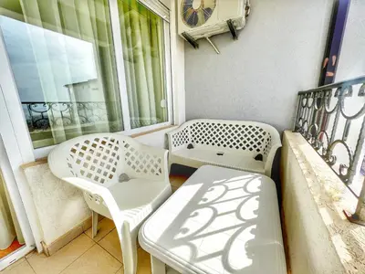 a balcony with two chairs and a table and a window at Adriatique Apartments in Dobra Voda