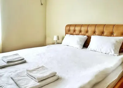 a large white bed with two towels on it at Adriatique Apartments in Dobra Voda