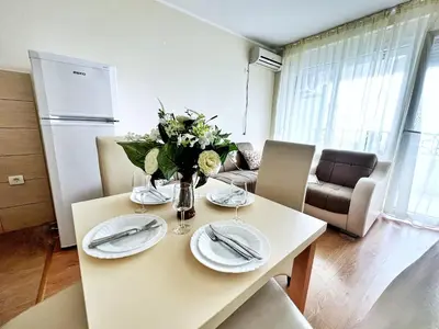 a kitchen and living room with a table and chairs at Adriatique Apartments in Dobra Voda