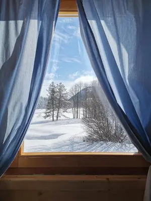 a window with a view of a snow covered field at Breeze Home Cottage in Cetinje