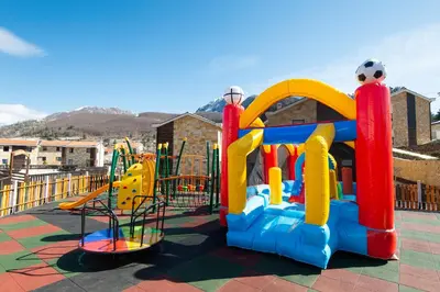 a childrens playground with a colorful play equipment at Ethno Village St George in Cetinje
