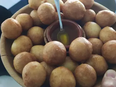 a bowl of potatoes with a spoon in it at Ethno Village St George in Cetinje
