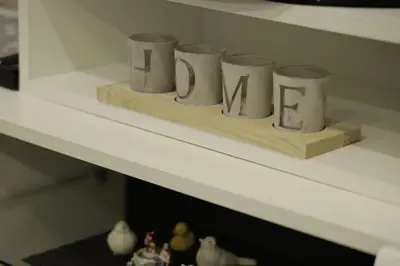 a shelf with four coffee cups sitting on it at Apartment Alexandra in Budva
