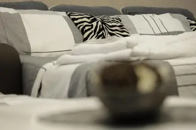 a close up of a bed with pillows on it at Apartment Alexandra in Budva