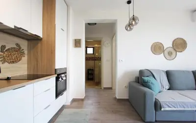 a living room with a couch and a table at Romantic sea view apartment in Petrovac in Petrovac na Moru