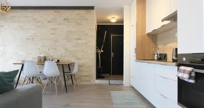 a kitchen and dining room with a table and chairs at Romantic sea view apartment in Petrovac in Petrovac na Moru