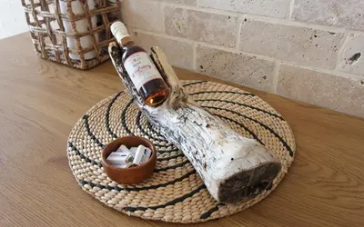 a bottle of wine sitting on a plate on a table at Romantic sea view apartment in Petrovac in Petrovac na Moru