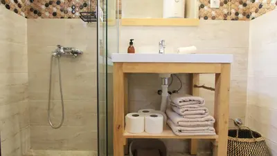 a bathroom with a sink and a shower at Romantic sea view apartment in Petrovac in Petrovac na Moru