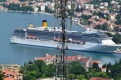 a cruise ship is docked in a harbor at Anastasija 2 in Kotor