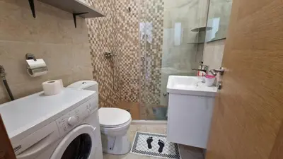 a bathroom with a washing machine and a sink at Anastasija 2 in Kotor