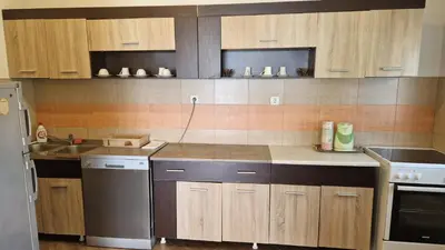 a kitchen with wooden cabinets and a sink and a dishwasher at Anastasija 2 in Kotor