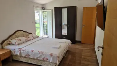 a bedroom with a bed and a window at Anastasija 2 in Kotor