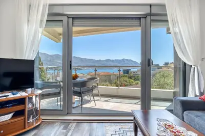 a living room with a view of the ocean at Apartment With a View in Budva