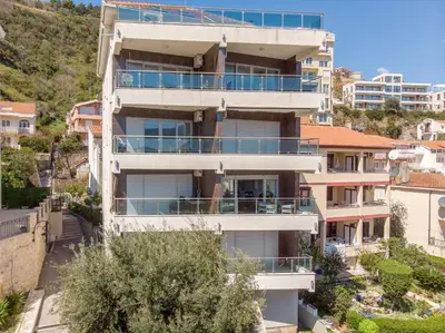 an apartment building with balconies on a hill at Apartment With a View in Budva