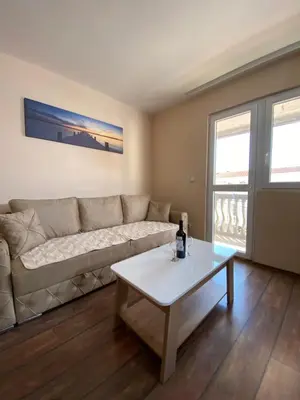 a living room with a couch and a coffee table at Apartments and Rooms Grande Casa in Bar