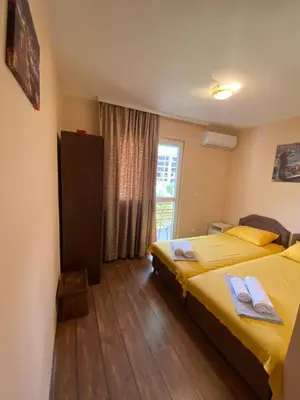 a hotel room with two beds and a window at Apartments and Rooms Grande Casa in Bar