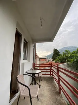 a table and chairs on the balcony of a house at Apartments and Rooms Grande Casa in Bar