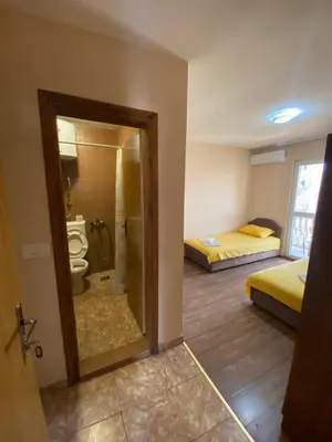 a room with a bathroom with a toilet and two beds at Apartments and Rooms Grande Casa in Bar