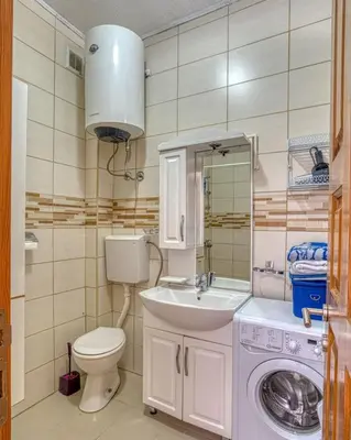 a bathroom with a toilet sink and a washing machine at Adriatic paradise in Budva