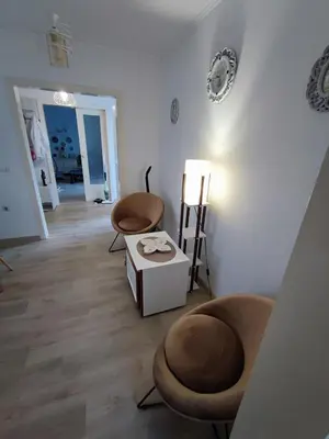 a living room with two chairs and a table at Apartment Barba View in Kotor