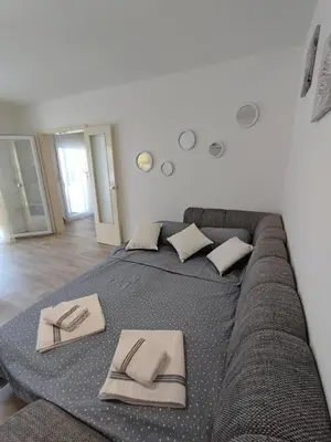 a large bed with napkins on it in a room at Apartment Barba View in Kotor