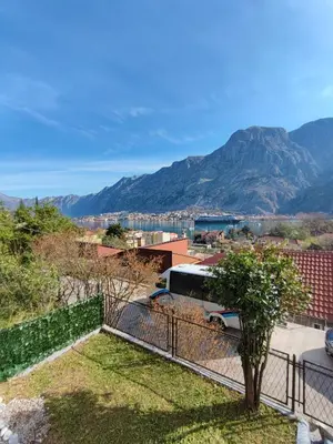 a bus parked on top of a building with a mountain at Apartment Barba View in Kotor