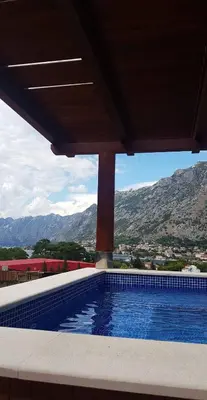 a swimming pool with a view of the mountains at Villa Vista Real in Kotor