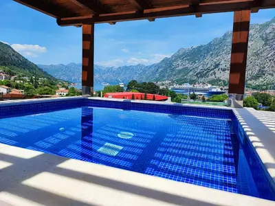 a swimming pool with a view of mountains at Villa Vista Real in Kotor