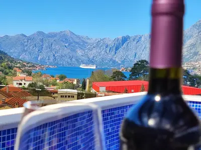 a bottle of wine sitting on top of a balcony at Villa Vista Real in Kotor