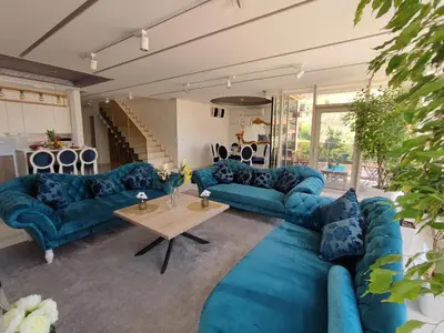 a living room with blue couches and a table at Villa Vista Real in Kotor