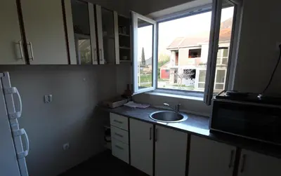 a kitchen with a sink and a window at Apart hotel St.Pijerre in Stari Bar