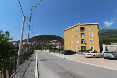 a street with cars parked on the side of a building at Apart hotel St.Pijerre in Stari Bar