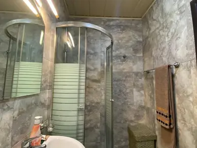a bathroom with a shower and a sink and a mirror at Apart hotel St.Pijerre in Stari Bar