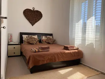 a bedroom with a bed with a heart on the wall at Apart hotel St.Pijerre in Stari Bar