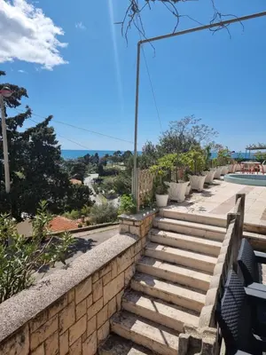 a set of stairs leading up to a wall at Apartman LOKI in Ulcinj