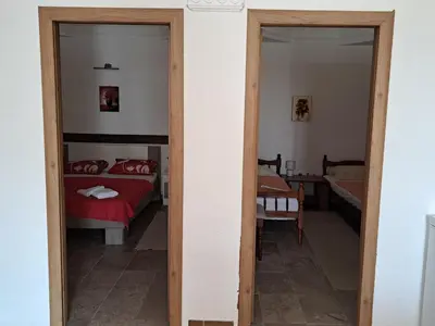a bedroom with a bed and a mirror at Apartman LOKI in Ulcinj