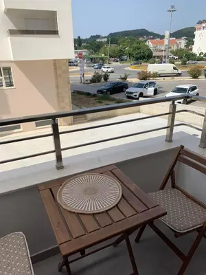 a table and a chair on a balcony at Apartman A2 in Ulcinj