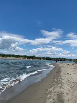 a beach with the ocean and footprints in the sand at Apartman A2 in Ulcinj
