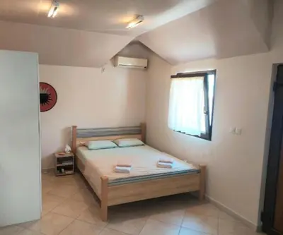 a bedroom with a bed in a room with a window at Mila's studio in Kotor
