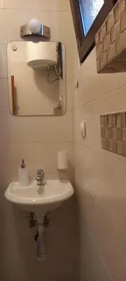 a bathroom with a white sink and a mirror at Mila's studio in Kotor