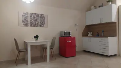 a kitchen with a small table and a red refrigerator at Mila's studio in Kotor