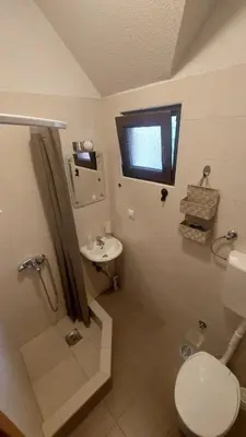 a bathroom with a toilet and a sink at Mila's studio in Kotor